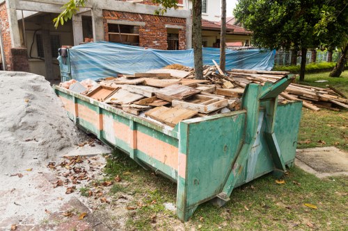 Company van and workers inspecting commercial waste containers