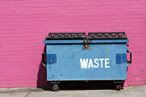 Crew member inspecting waste containers at site entrance