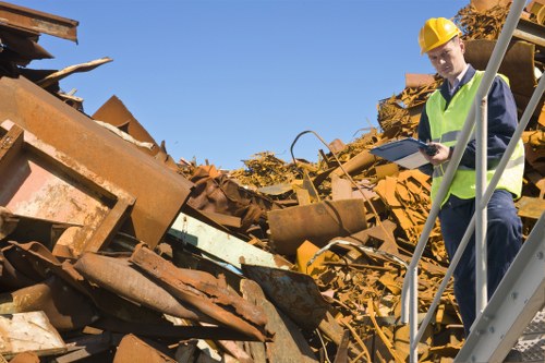 Workers loading a van with shop clearance waste